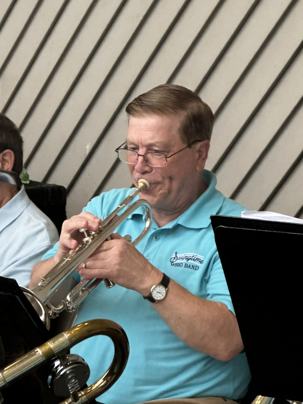 SwingTime musician Joe Commarata playing the trumpet during 2026 Austintown Park concert